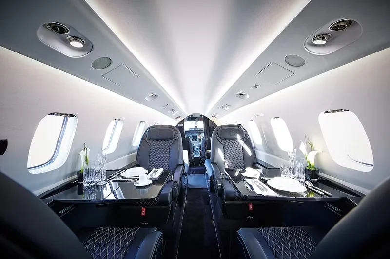 Piaggio Avanti EVO cabin interior with Italian-designed leather seating and table settings